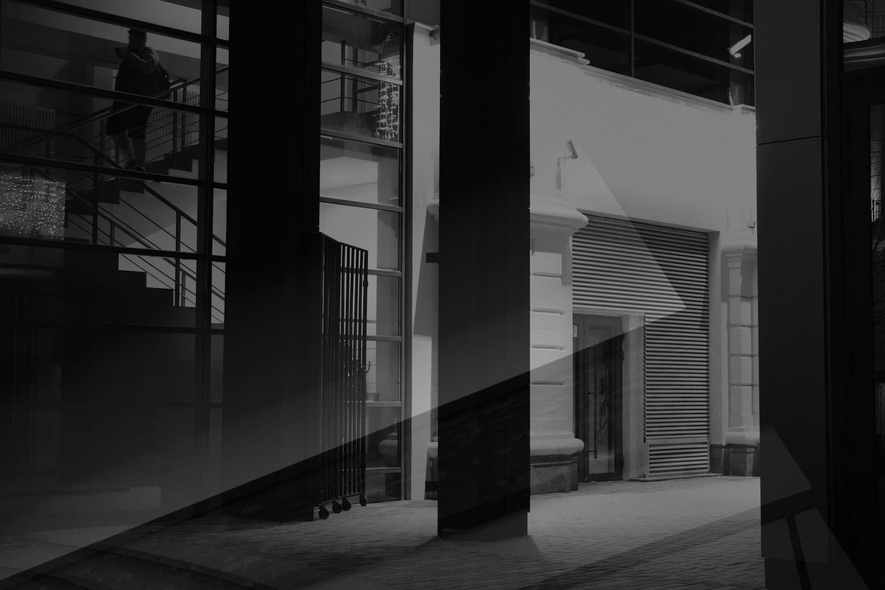 Monochrome architectural facade divided by sharp geometric shadows